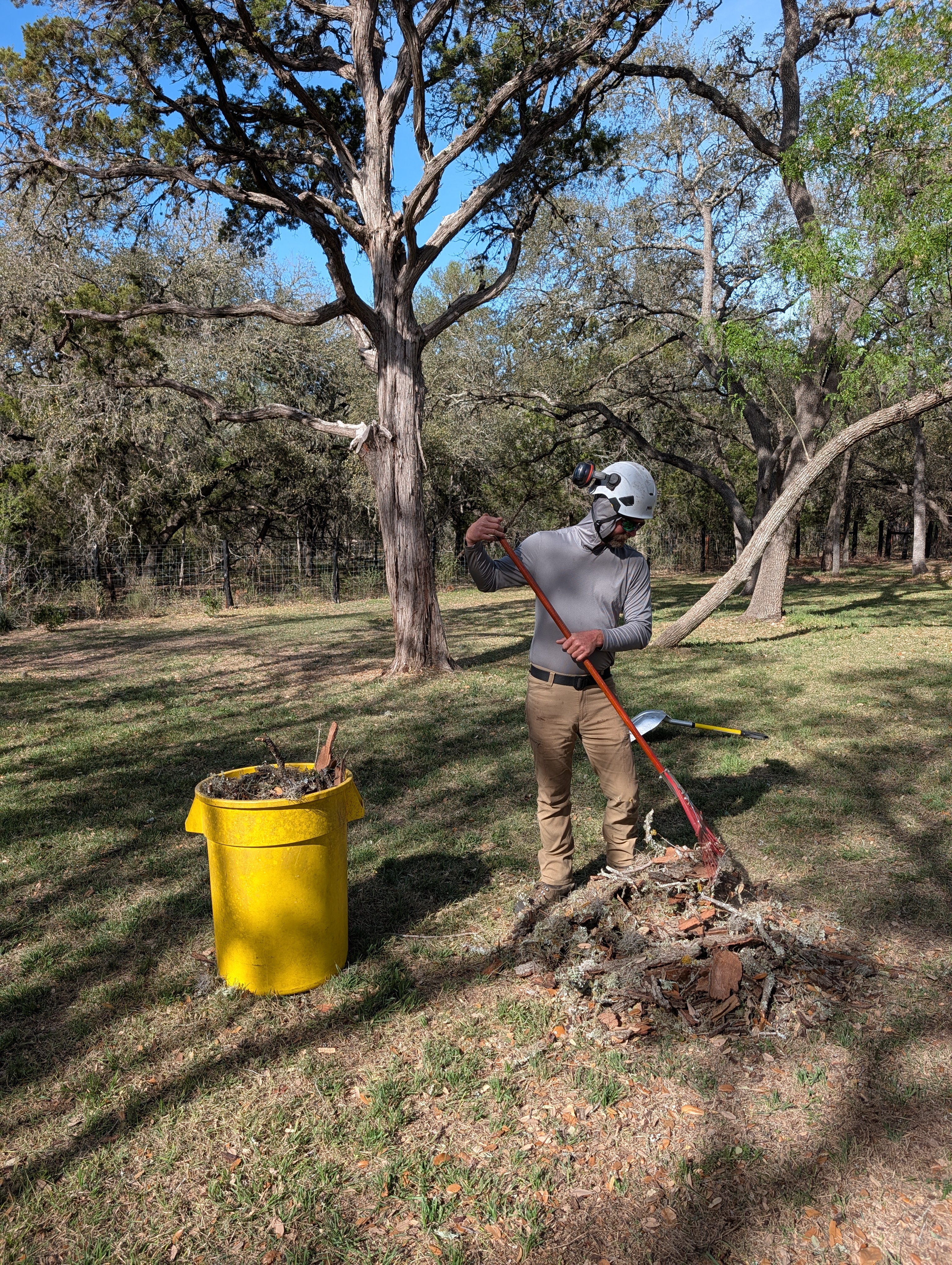 Adam from Timber Love and Care raking a New Braunfels yard